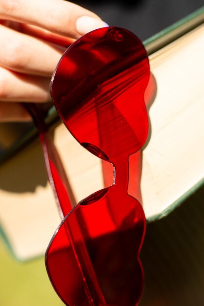 Red heartshaped glasses on a book