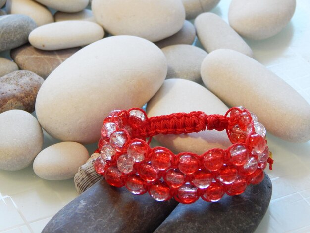 Red hippie bracelet on stones