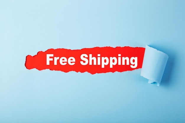 Red hole in blue paper with Free Shipping word