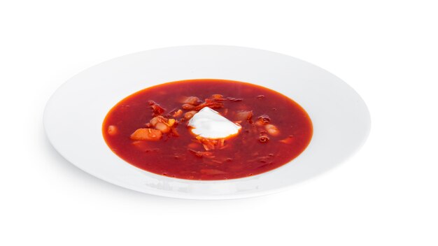 Red, hot borscht - beet soup with sour cream isolated on white.