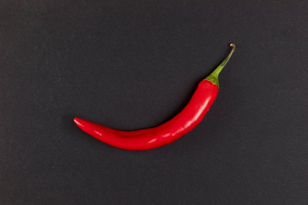 Red hot chili pepper on black background