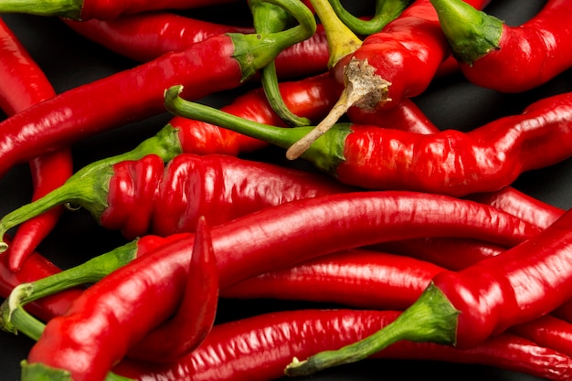 Red hot chili peppers on a black surface