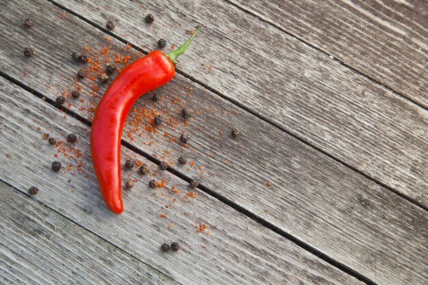 Red hot chili peppers on wooden background