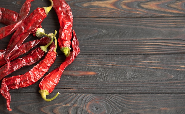 Red hot chilli peppers on a wooden table