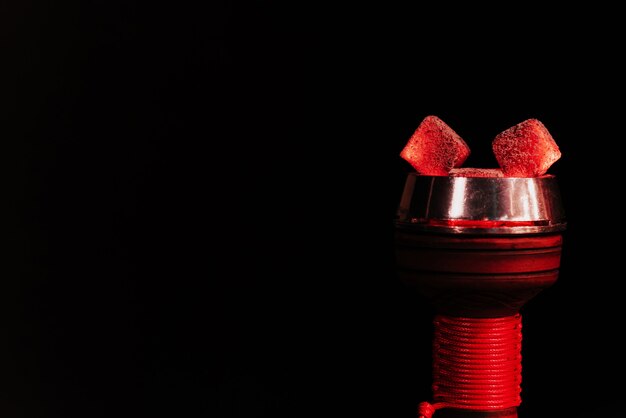 Red hot coals of a hookah in a shisha bowl