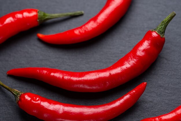 Red hot pepper on a dark background. Shale plate..