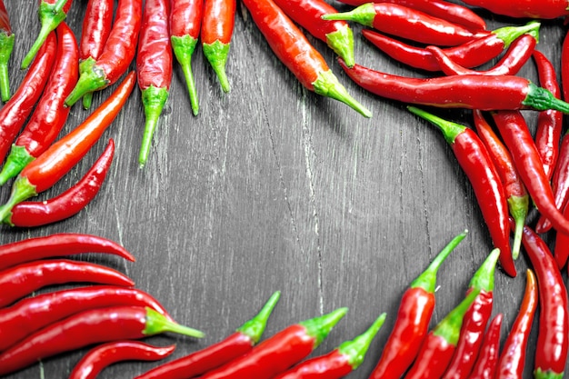 Red hot peppers frame background