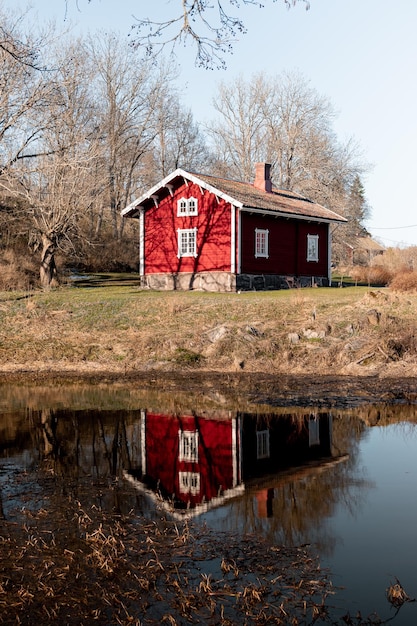 red house with a reflection in the water