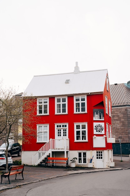 Red house with white roof on the street in Reykjavik, the capital