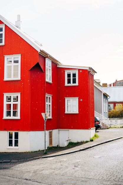 Red house with white roof on the street