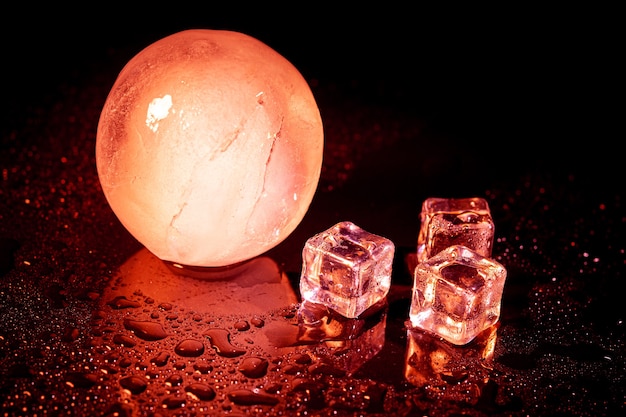 Red ice ball reflection on black background.