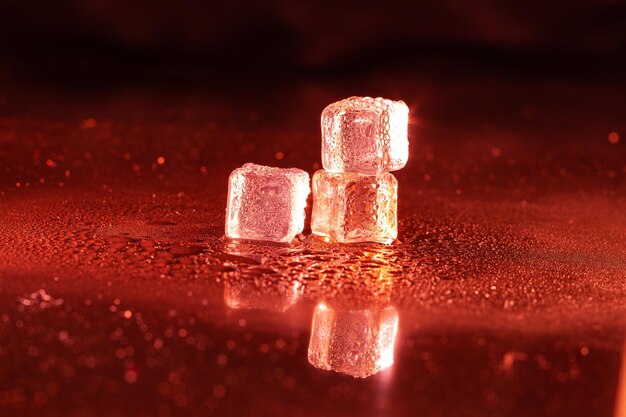 Red ice cubes on black background