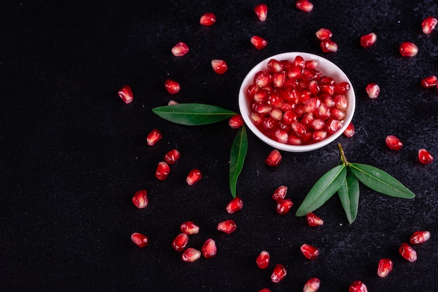 Red juice pomegranate on dark background