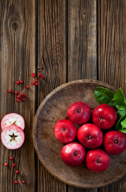 Photo red juicy apples in a vintage rustic wooden bowl