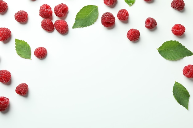 Red juicy raspberries on a white background, space for text.