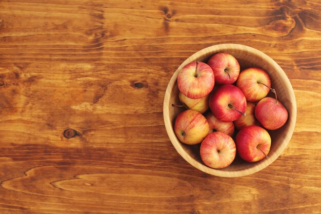 Red juicy young tasty apples on a bright even background