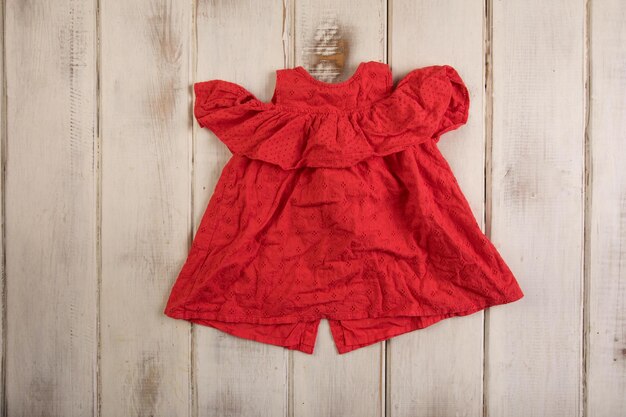 A red jumpsuit with a ruffle detail and a bow tie.