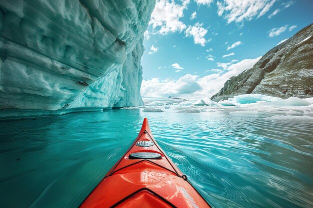 Red kayak in icy blue waters among towering glaciers