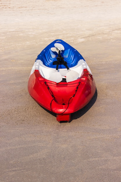 Red kayaking boat on the tropical beach area 