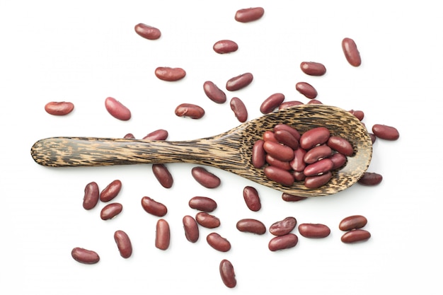 Red kidney beans on a wooden spoon isolate on white