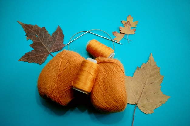 Red knitting threads on a blue background