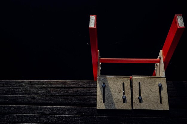 Red ladder in dark sea