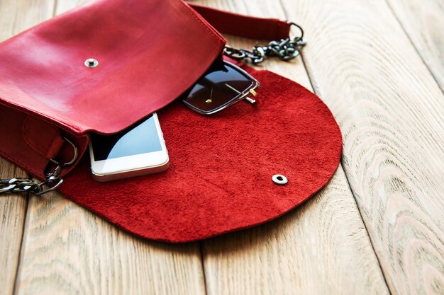 Photo red leather bag and phone