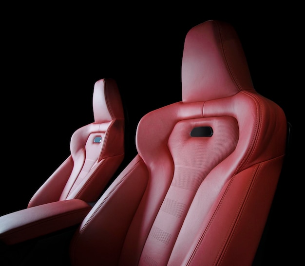 Фото red leather car seats isolated on black background