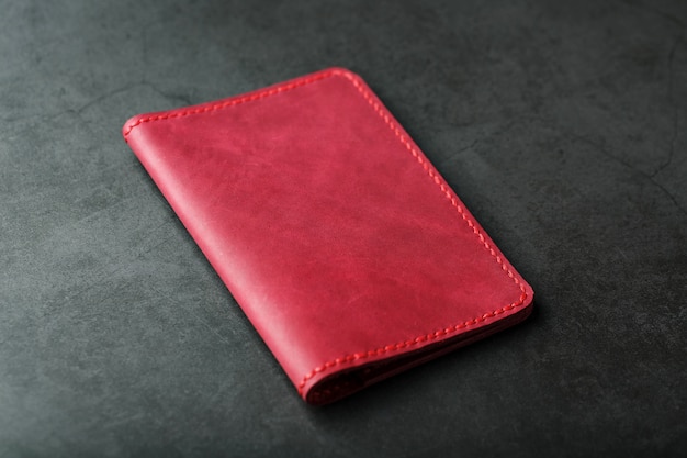 Red leather cover for a passport. Genuine leather, handmade, close up stitching