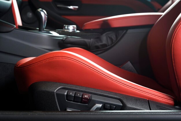 red leather driver seat with stitching inside luxury car interior
