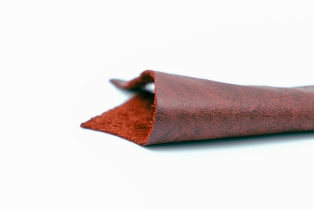 Red leather is folded on a white background