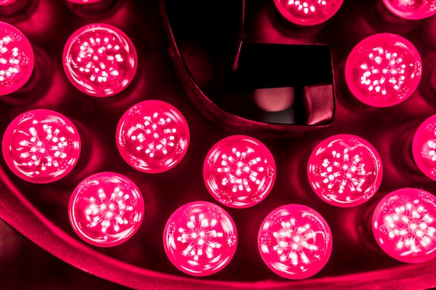 Photo red led light bulb against black background