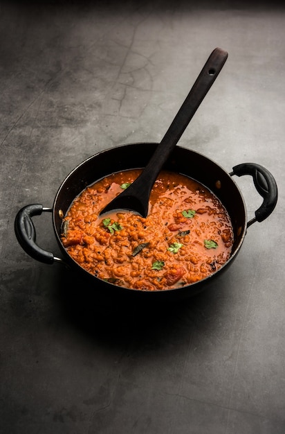 Red Lentil Cooked Dal or Dhal or Masoor daal tadka served in a bowl, selective focus