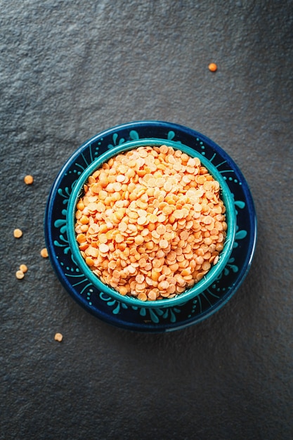 Red Lentil Halves in a Wooden Spoon