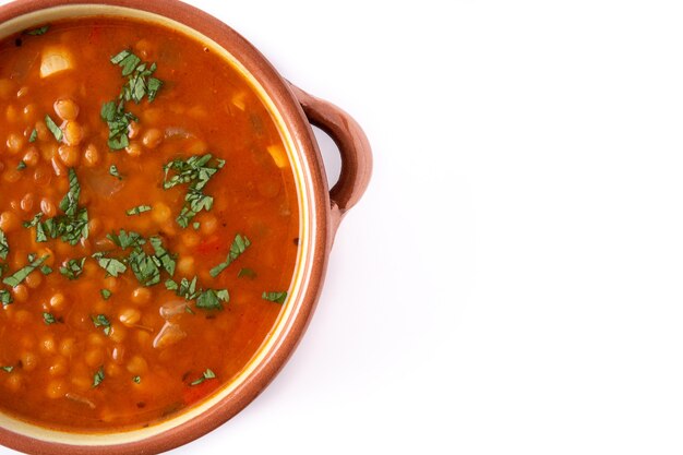 Red lentil soup in bowl isolated on white background