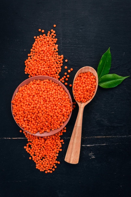 Red lentils On a wooden background Top view Copy space