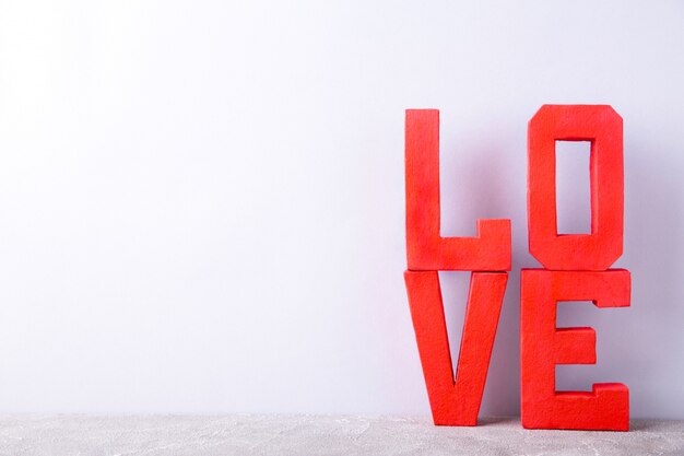 Red letters love on grey . LOVE word.