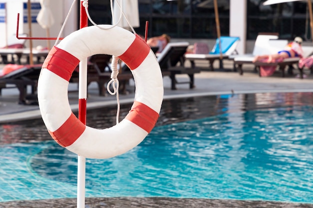 Red lifebuoy ring near the swimming pool