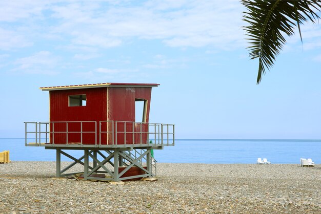 Red lifeguard hut on the empty beach