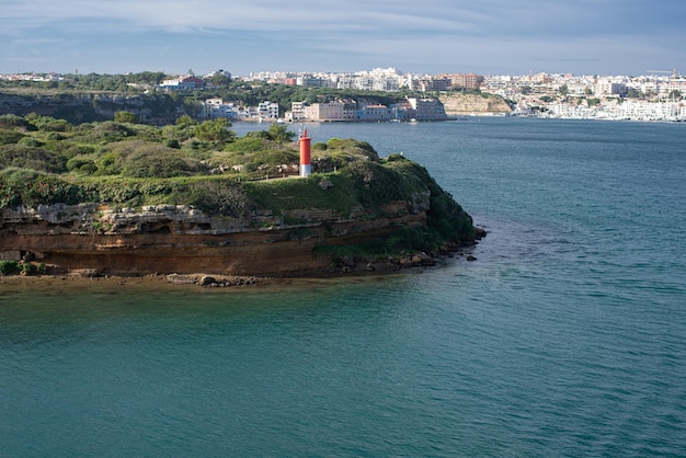 red lighthouse on L'Illa del Rei hospital island in the middle of the main navigable entry channel t