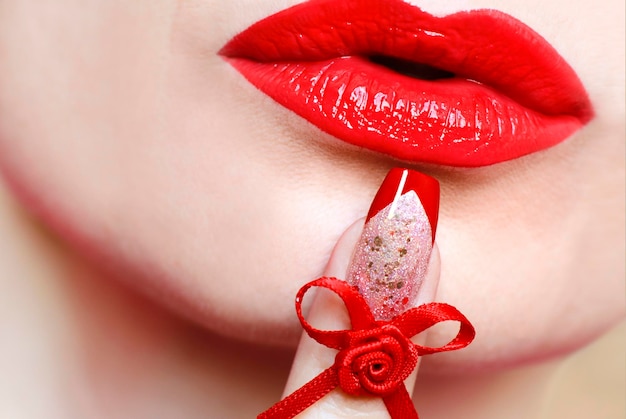 Red lips and French nail design with bow