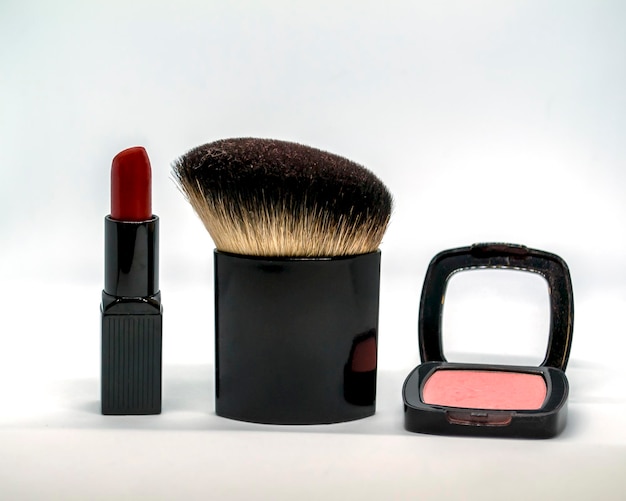 Red lipstick blush and cosmetic brush