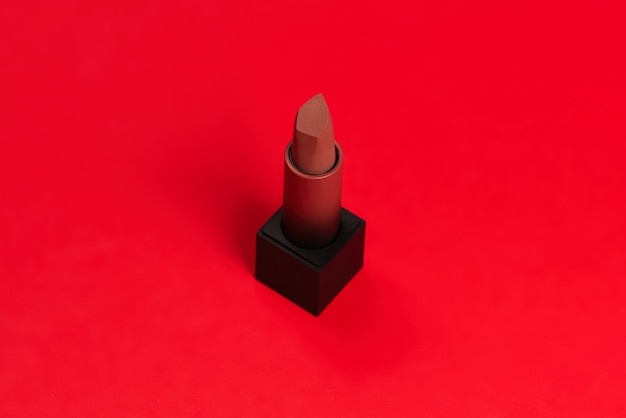 Photo red lipstick on a red surface. makeup for women.