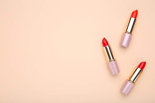 Red lipsticks on beige, make up