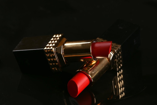Red lipsticks on black background