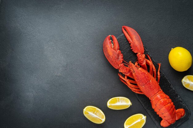 Red lobster with lemon on dark background Directly above copy space