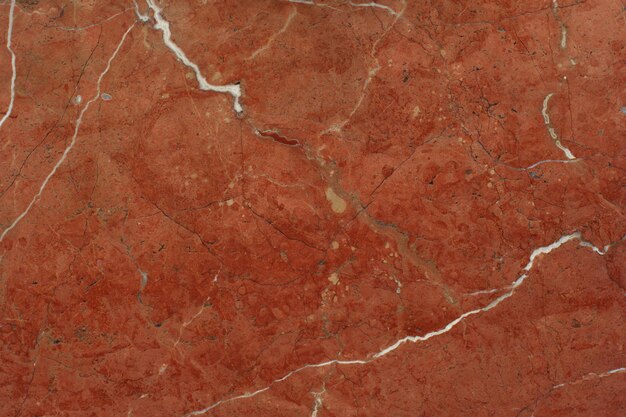 赤い大理石のテクスチャ背景のクローズ アップ デザインの背景