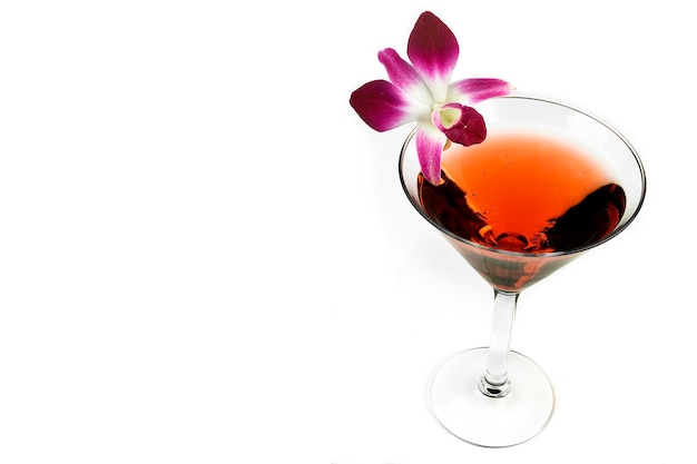 Red Martini cocktail with flowers isolated on white background with space for your text or design