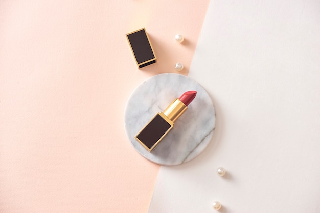 Red matte lipstick on a marble pedestal