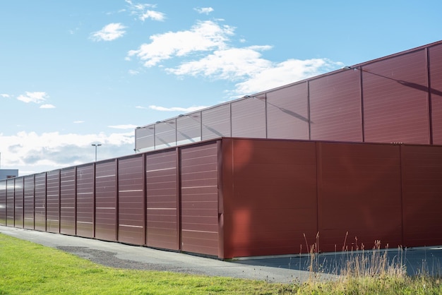 Red metal boxes for temporary storage and room for building material A modular cladded storage facility Portable office containers or prefabricated modular buildings for construction workers on site